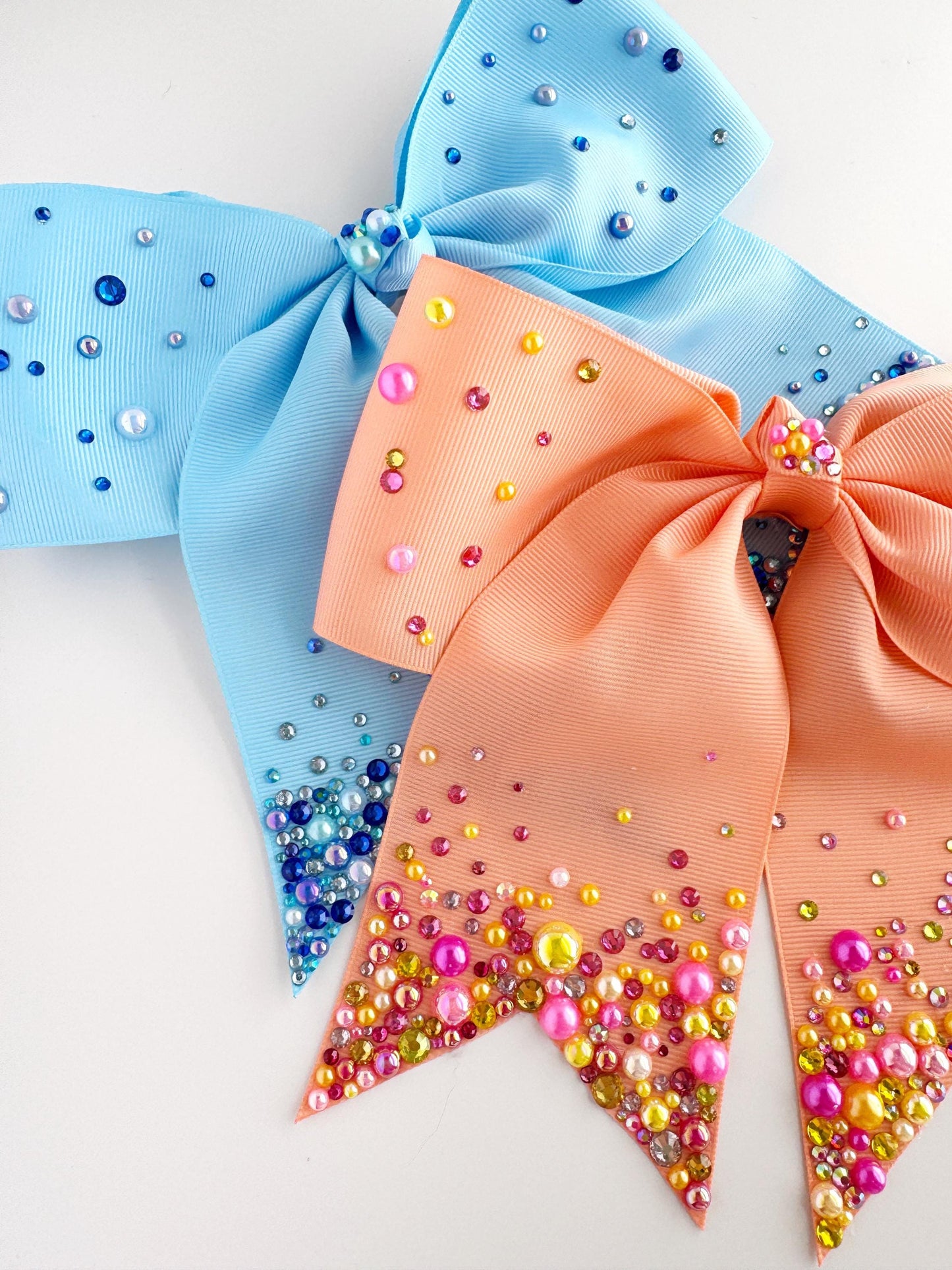 three colorful bows adorned with small, multicolored beads.