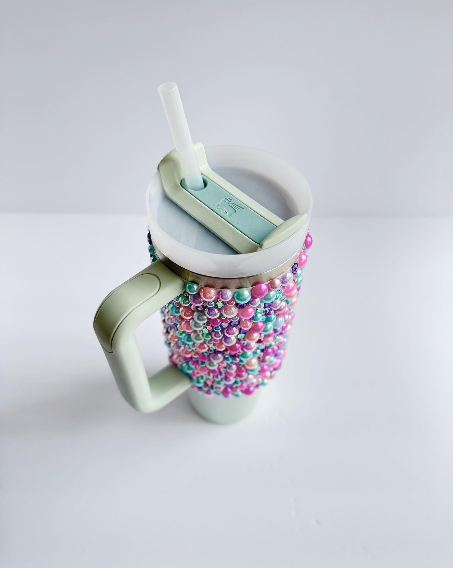 a cup with beads and a toothbrush in it