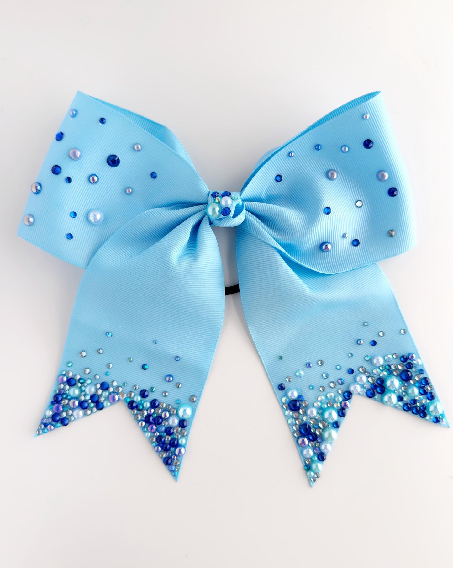 A light blue ribbon adorned with small blue and silver beads, creating a sparkling effect.