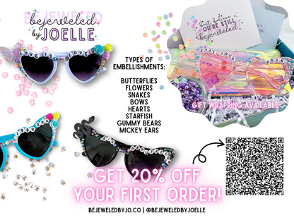 The image is an advertisement for a jewelry store called "Be Jeweled by Joelle", featuring a variety of colorful and decorated sunglasses and other accessories. The ad includes text promoting a special offer of 20% off on the first order of these items.