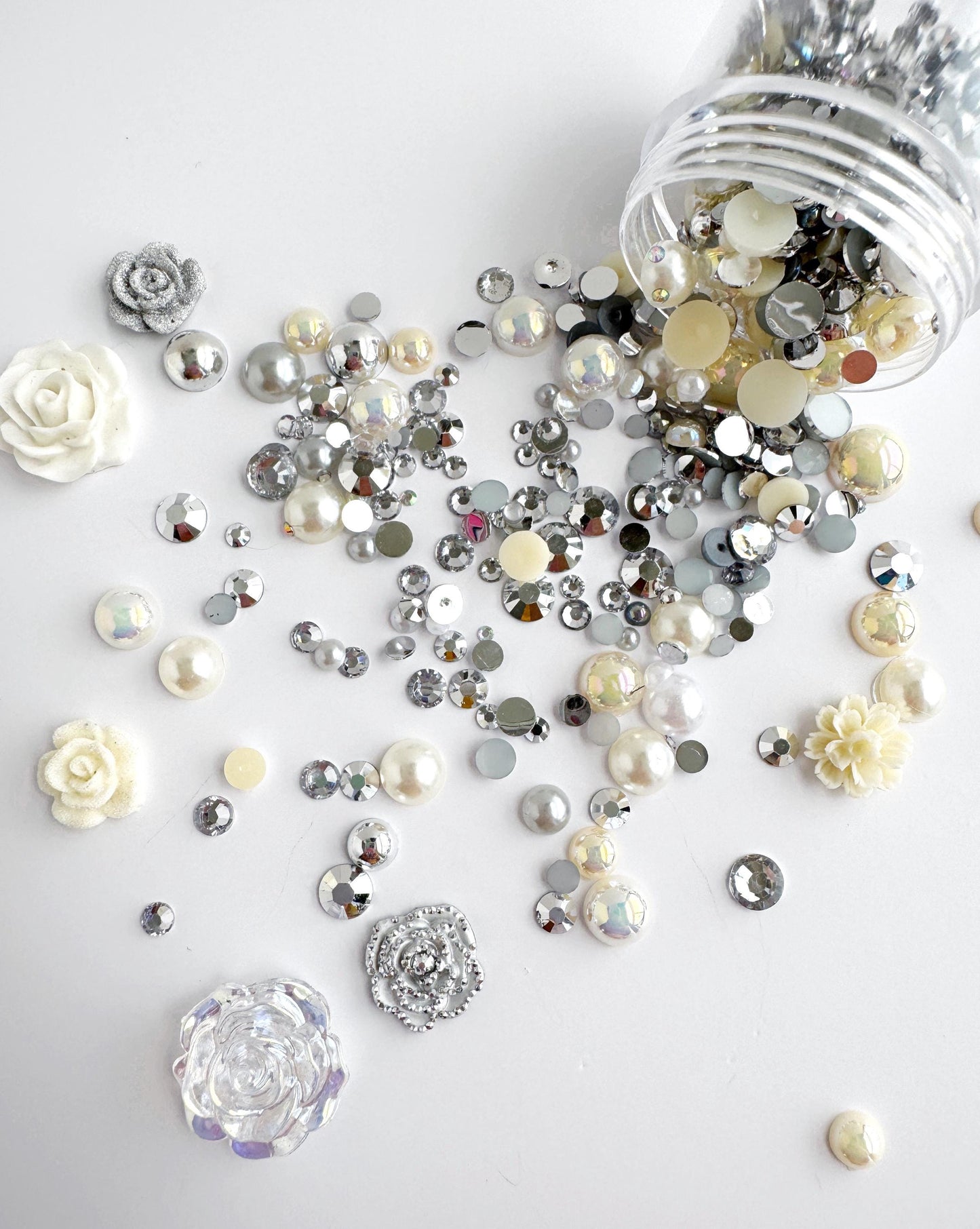 a collection of various shiny, metallic, and crystal-like objects scattered across a white background.