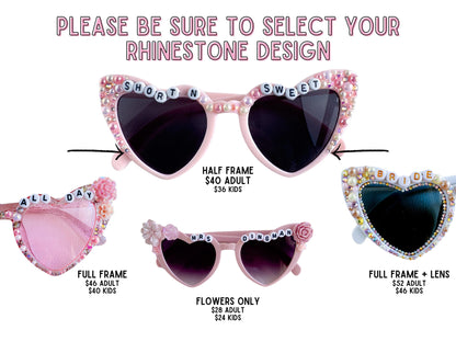 a collection of pink heart-shaped sunglasses with various designs and text, including &quot;SHORT N SWEET&quot;, &quot;BRIDE&quot;, &quot;ALL DAY&quot;, &quot;DINGMAN&quot;, and &quot;FLOWERS ONLY&quot;. The sunglasses are displayed in different sizes and frame styles, with prices ranging from $46 to $54 for adults and $40 to $44 for kids.