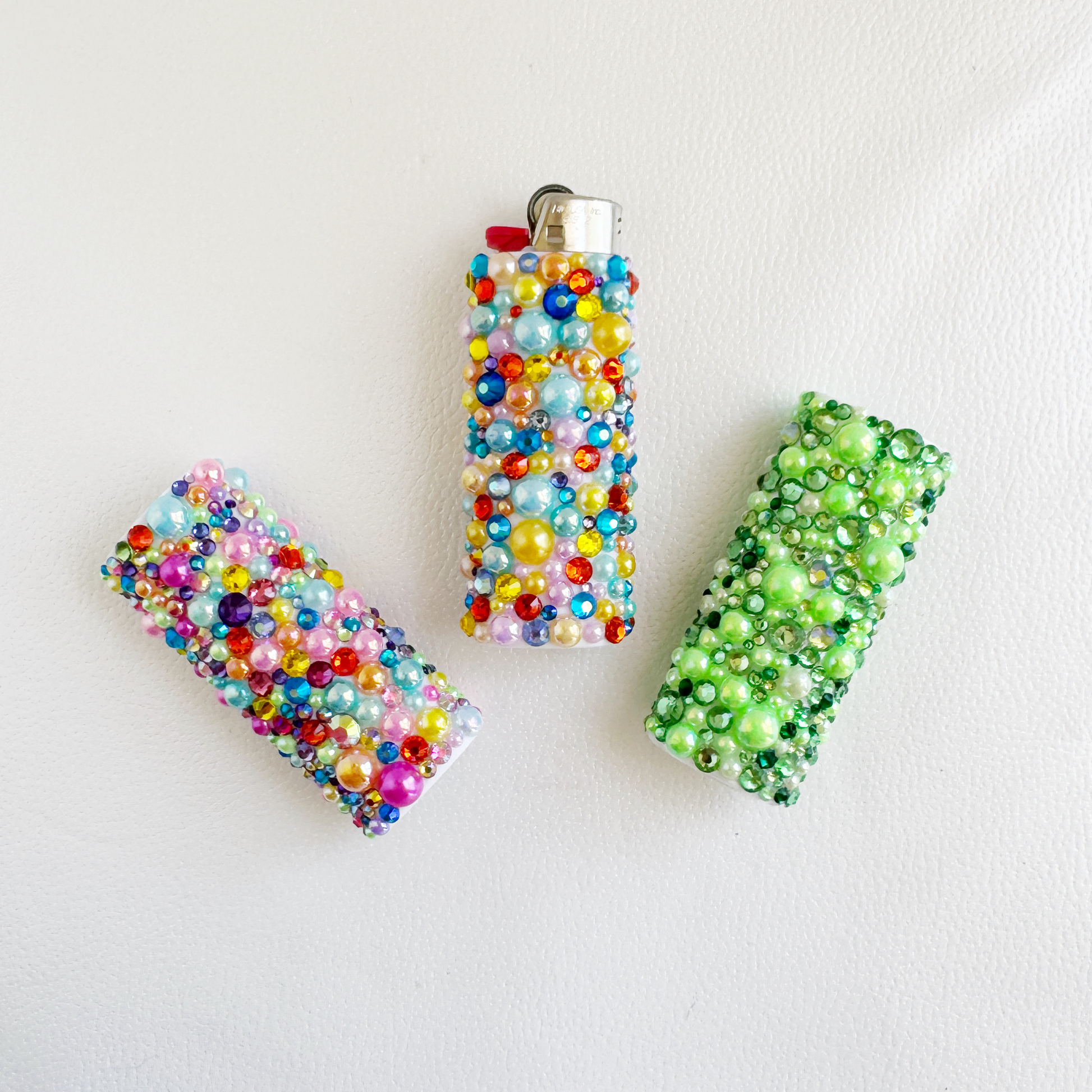 three different colored beads on a white surface