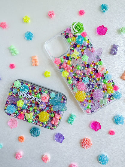 a cell phone case sitting next to a case filled with colorful beads