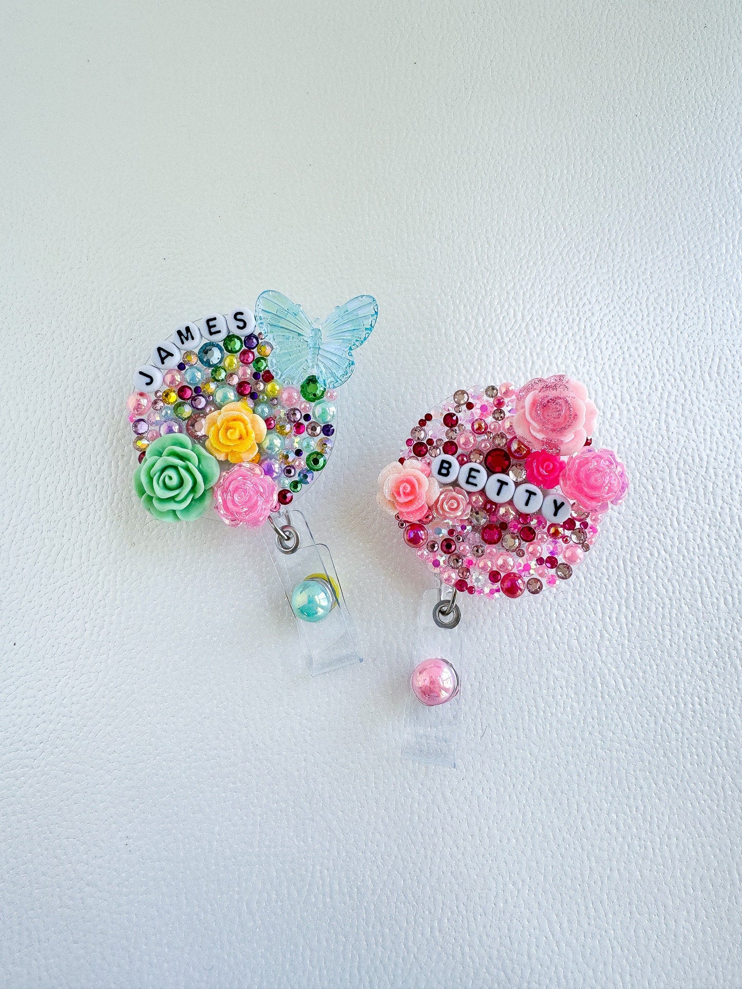 a couple of brooches sitting on top of a white surface