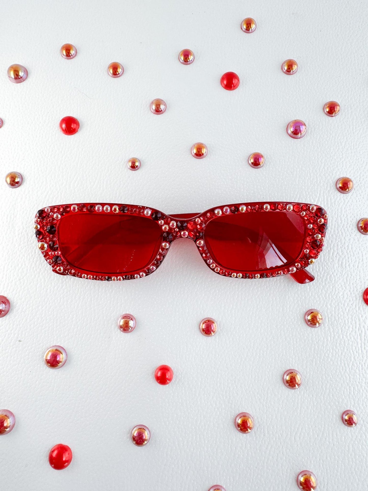 a pair of red sunglasses sitting on top of a table