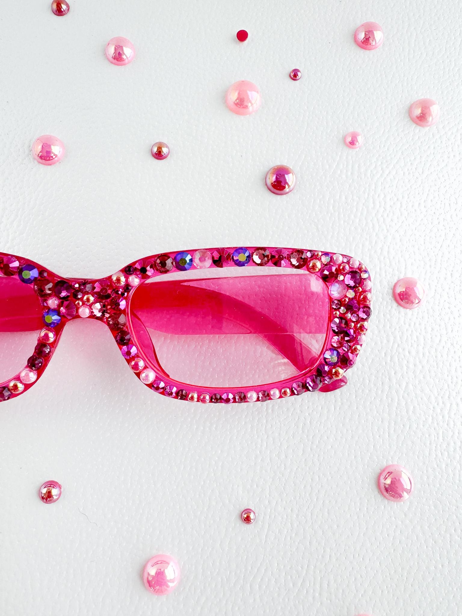 a pair of pink sunglasses sitting on top of a table