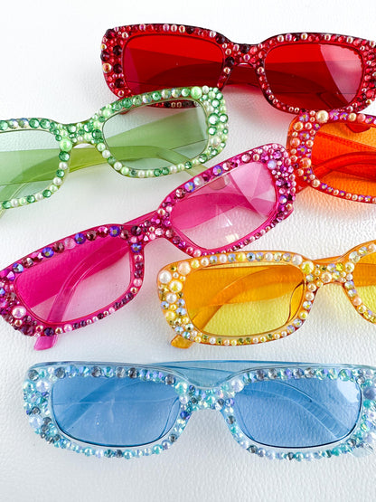 a group of four pairs of colorful sunglasses