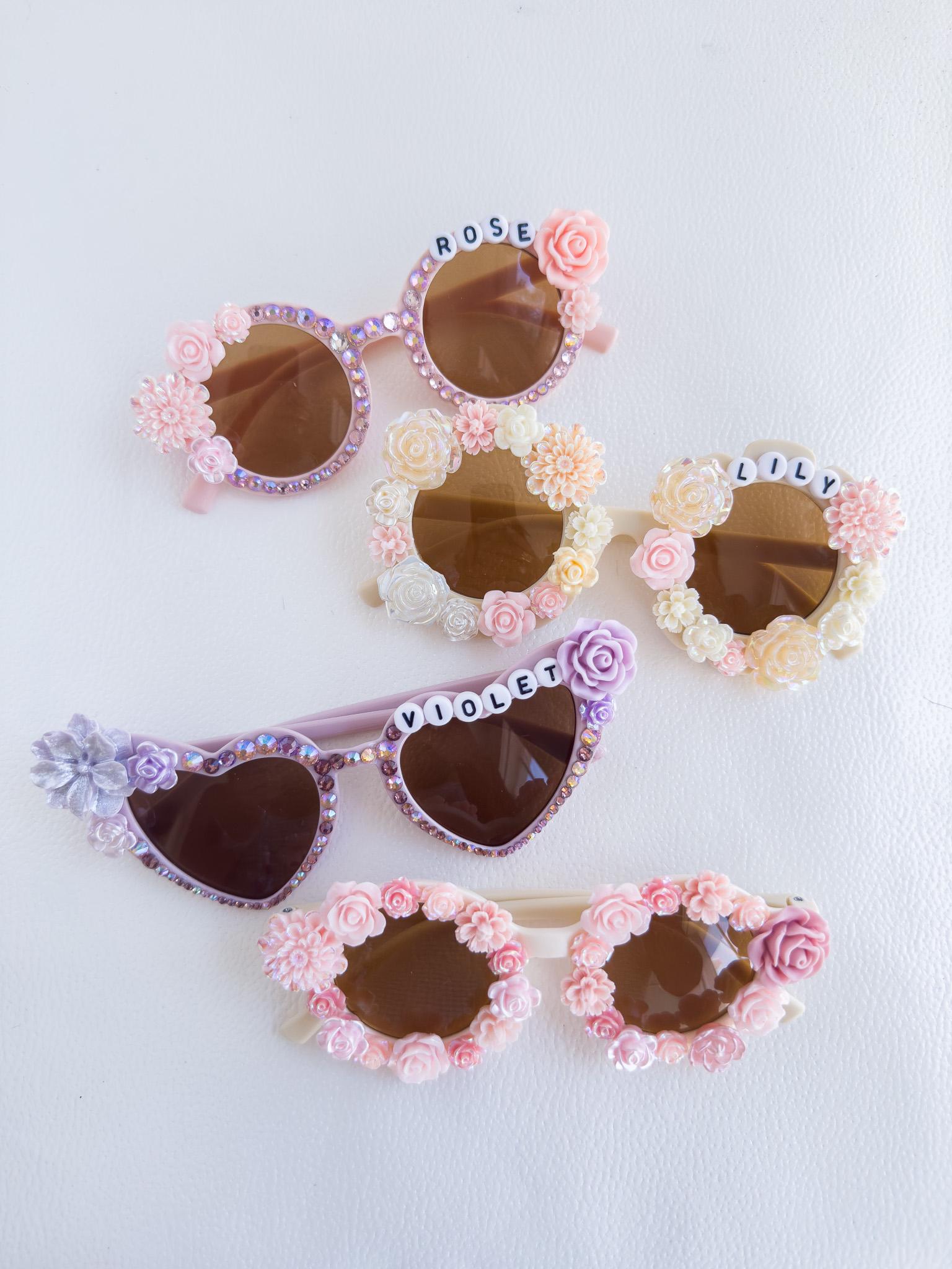 a group of four sunglasses with flowers on them